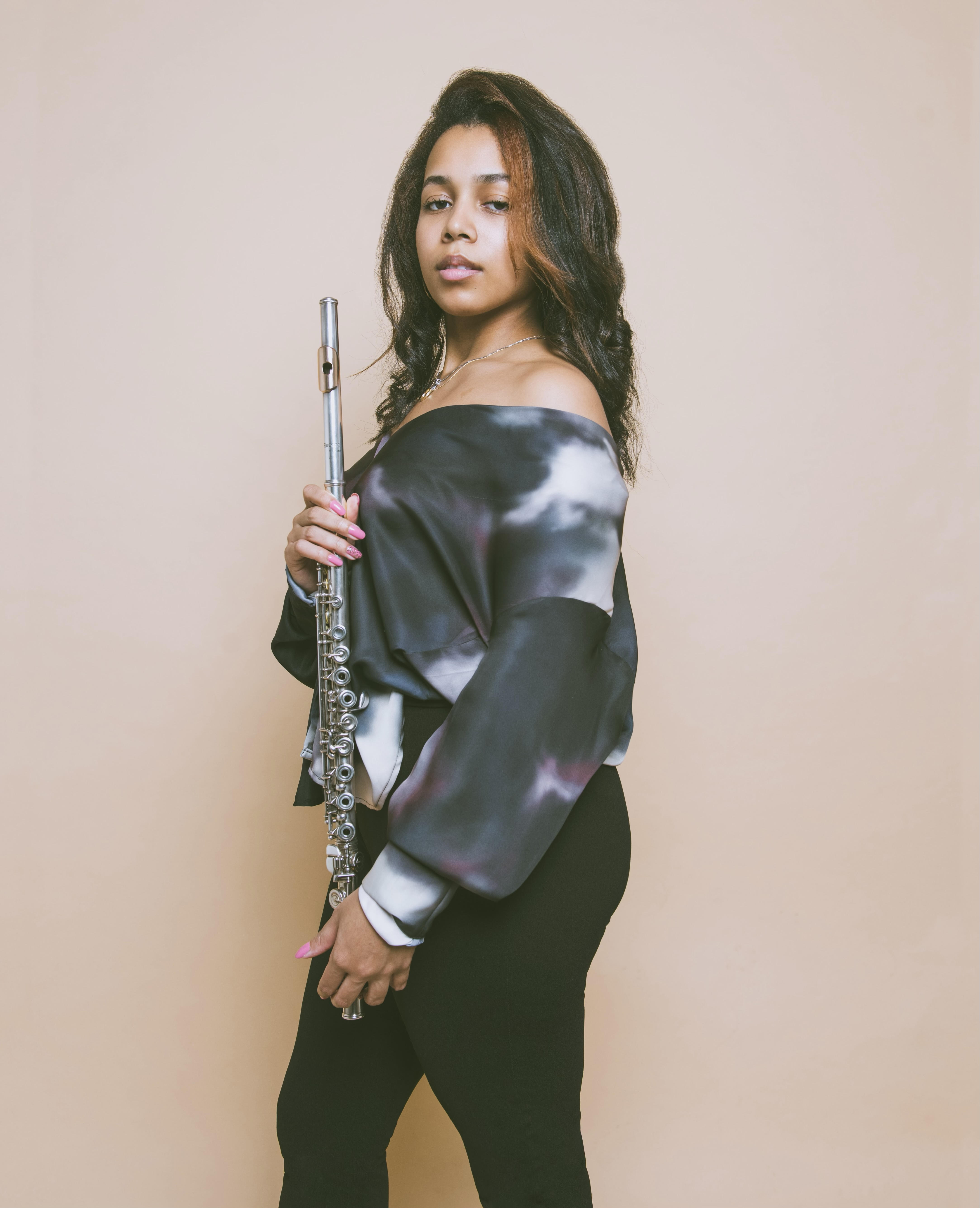 A woman poses with a flute.